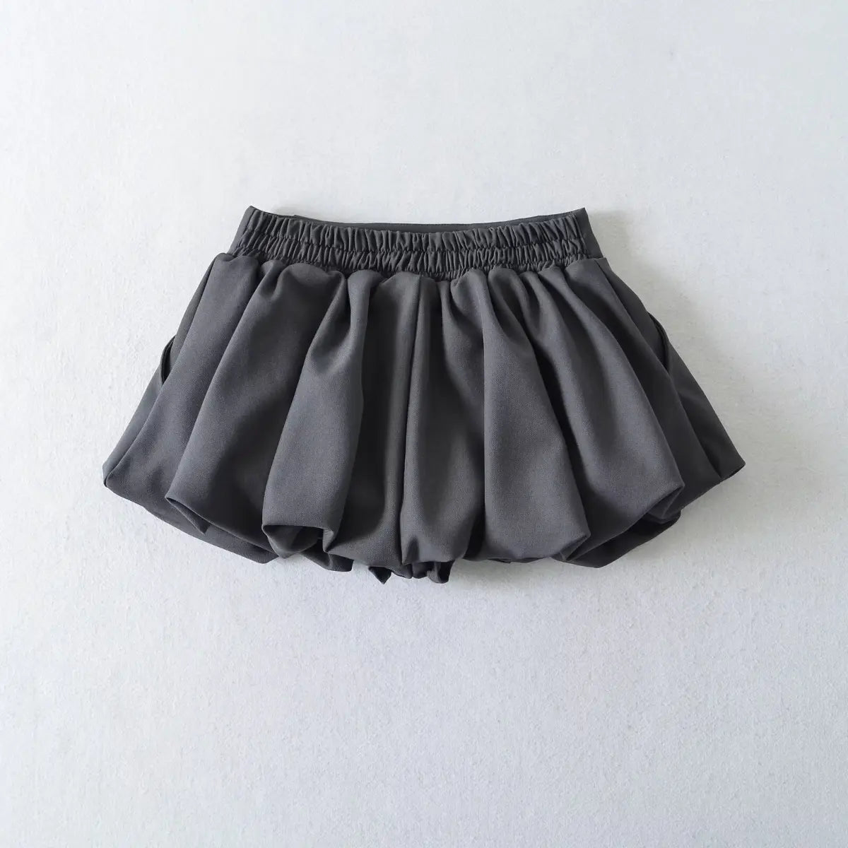 Dark grey high-waisted bubble mini skirt, full back view on white background