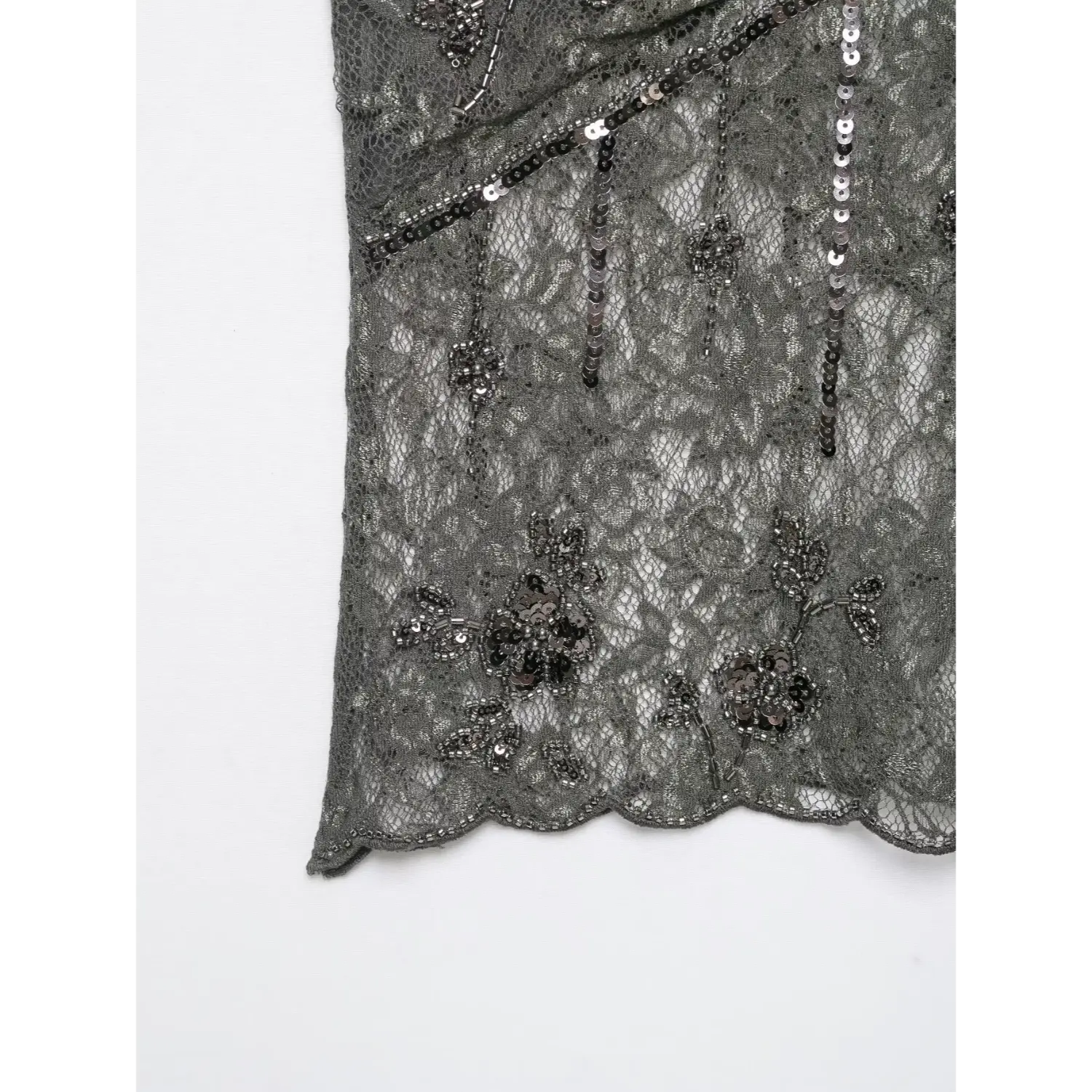 Close‑up bottom scalloped hem with flower sequin bead embroidery on dark grey sheer lace camisole