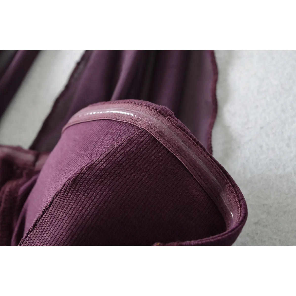 Close-up of the bust cup, showing the silicone grip tape inside for added support and the ribbed knit texture.