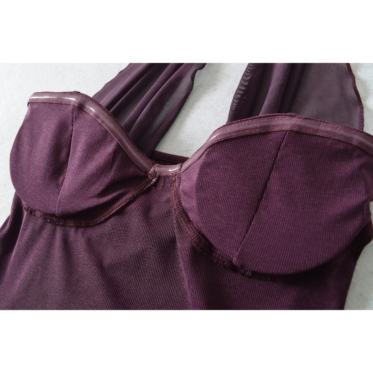 Close-up of the bust cup, showing the silicone grip tape inside for added support and the ribbed knit texture.