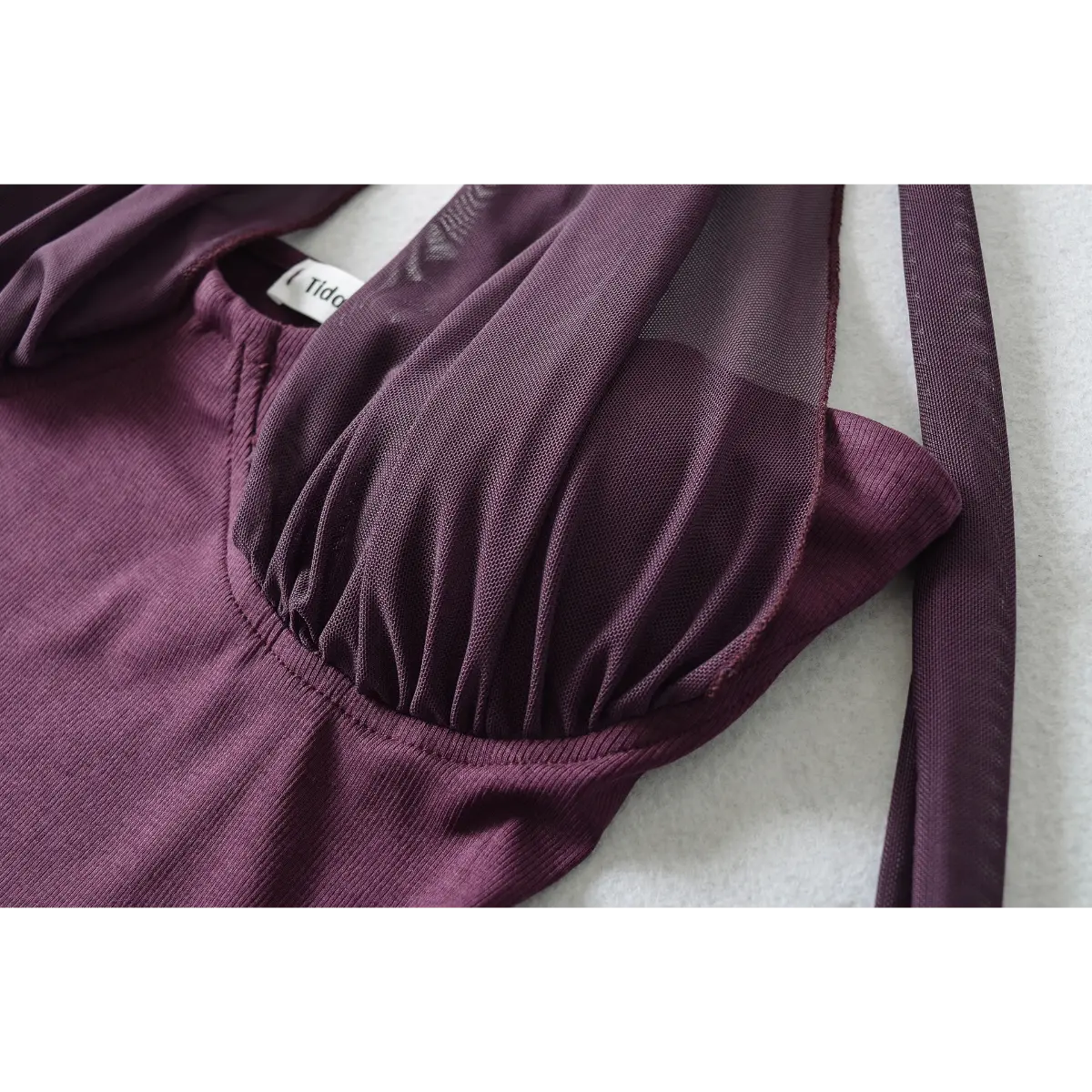 Close-up of the gathered sheer mesh overlay at the bust, showcasing the soft, flowing texture