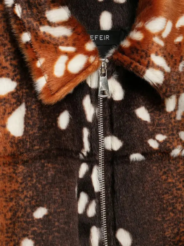Macro close-up of silver zipper pull and fur texture