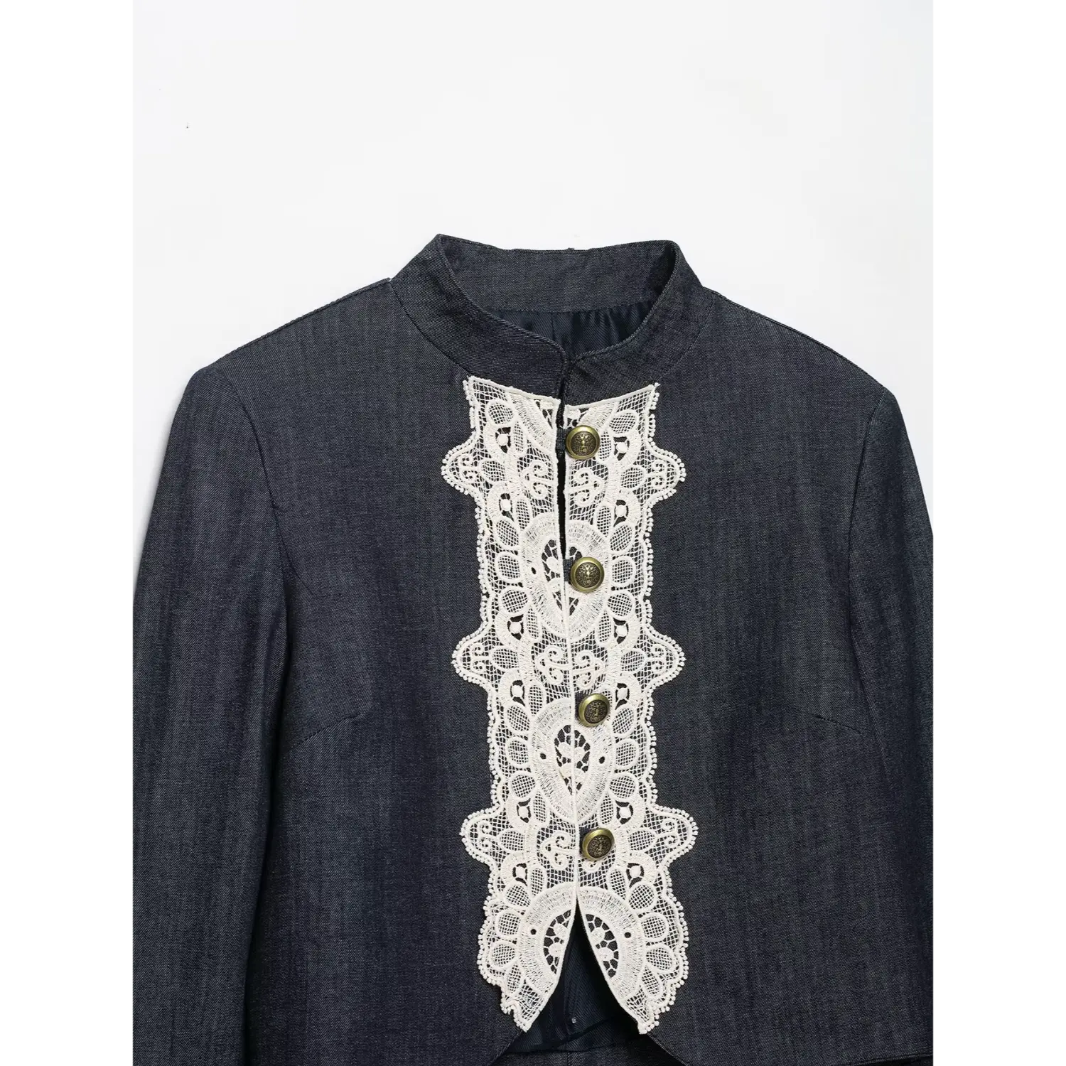 Detail shot front white lace panel and antique brass buttons denim cropped jacket