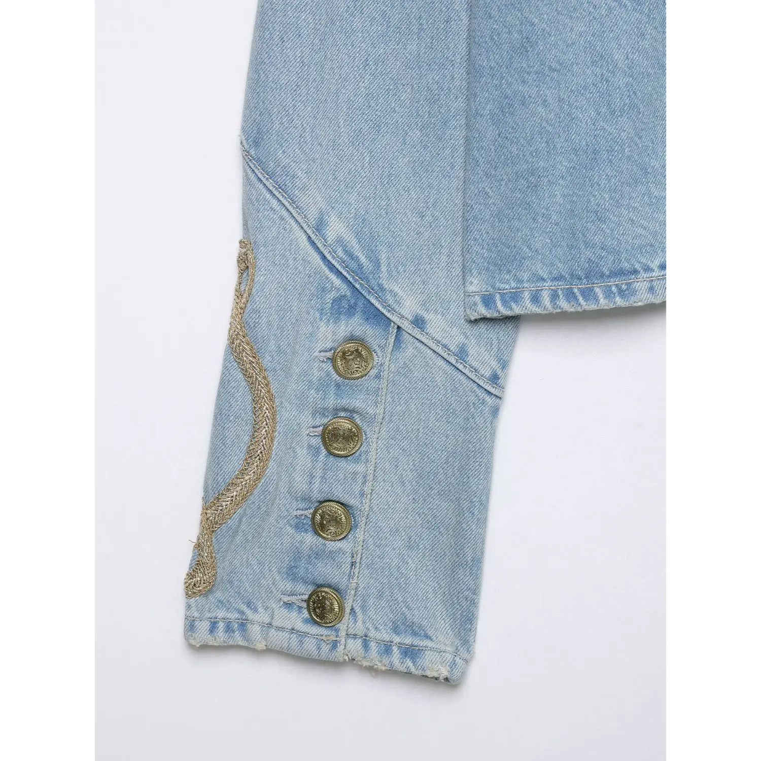 Close-up sleeve cuff detail gold woven rope embroidery & engraved brass buttons on military denim jacket