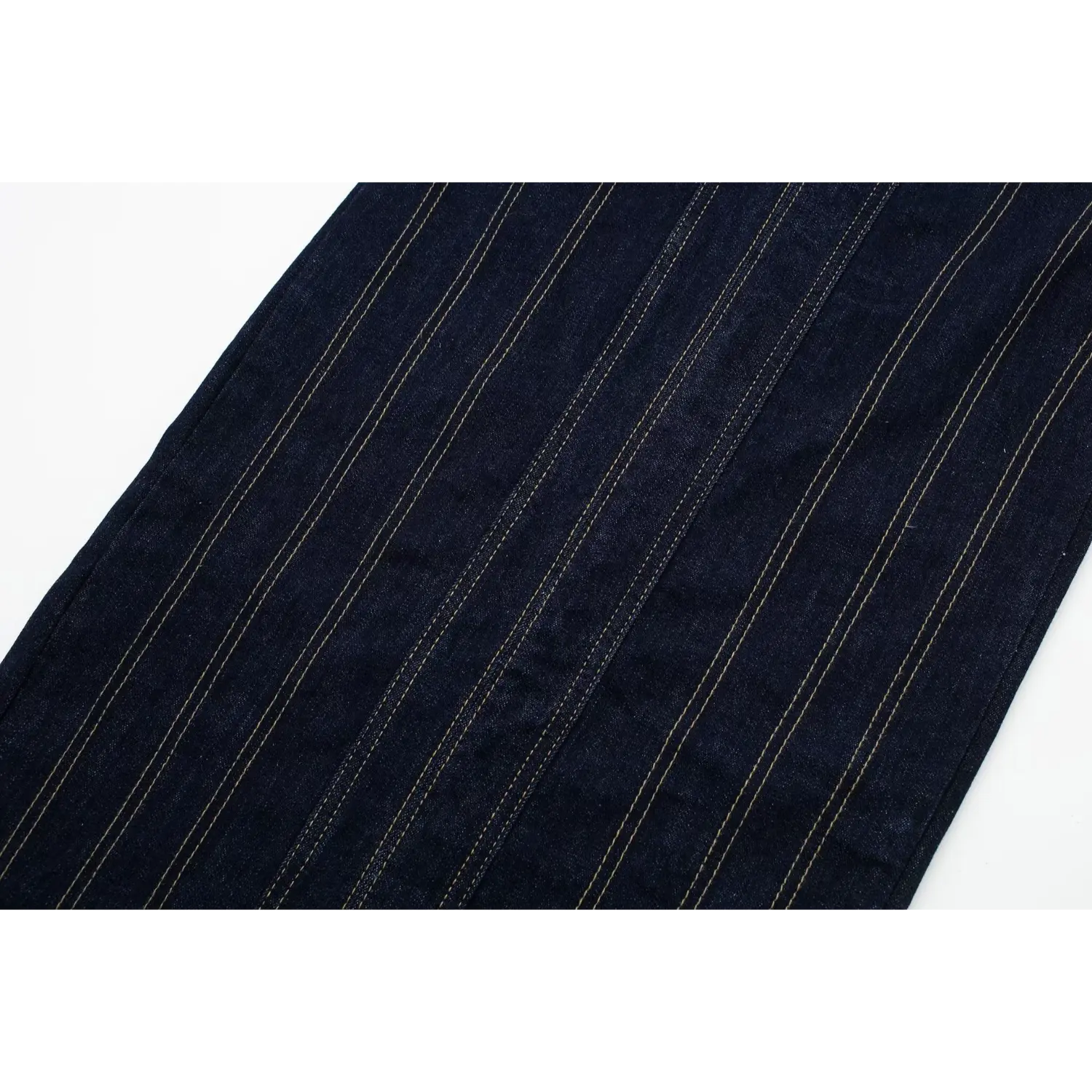 Macro shot showing vertical contrast yellow topstitching details on dark indigo denim midi dress body