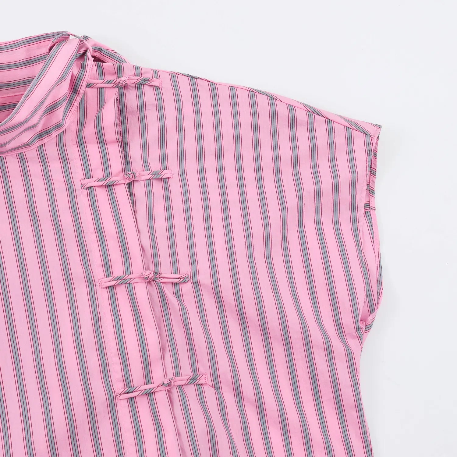 Detail asymmetrical placket with matching fabric chinese knot buttons, dolman sleeve armhole