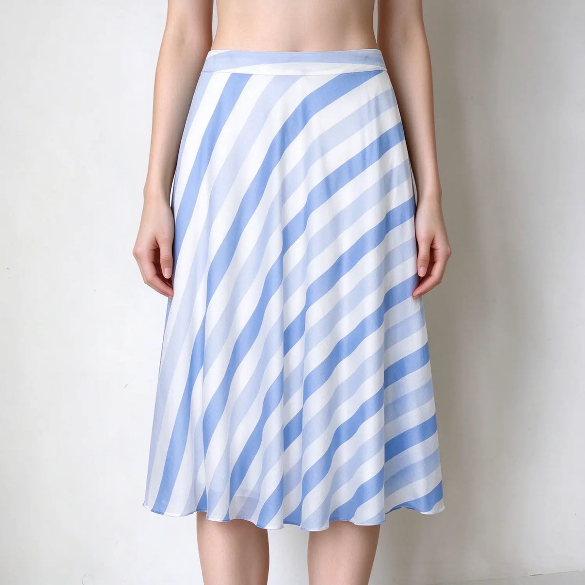 Model wearing diagonal stripe bias cut A-line midi skirt, front view