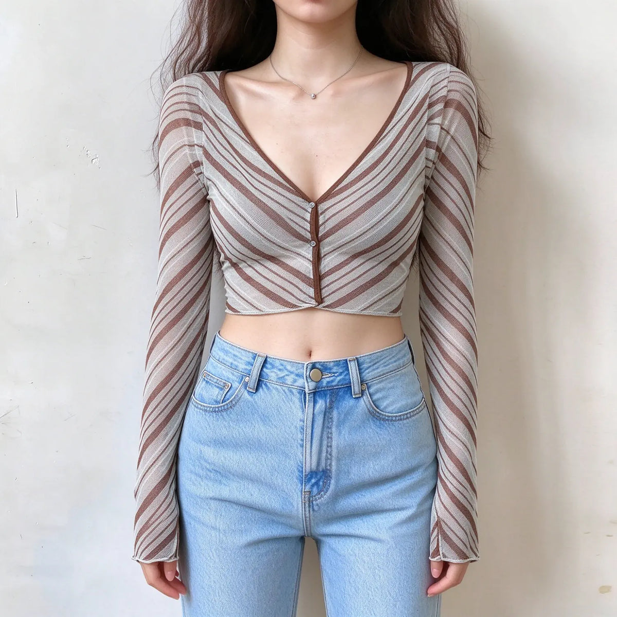 Model wearing diagonal stripe cropped V neck knit cardigan with jeans, front view