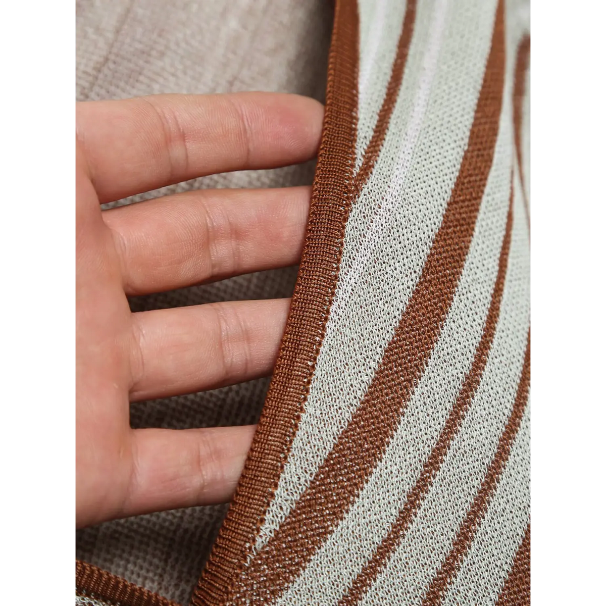 Close-up of brown knit trim and button placket