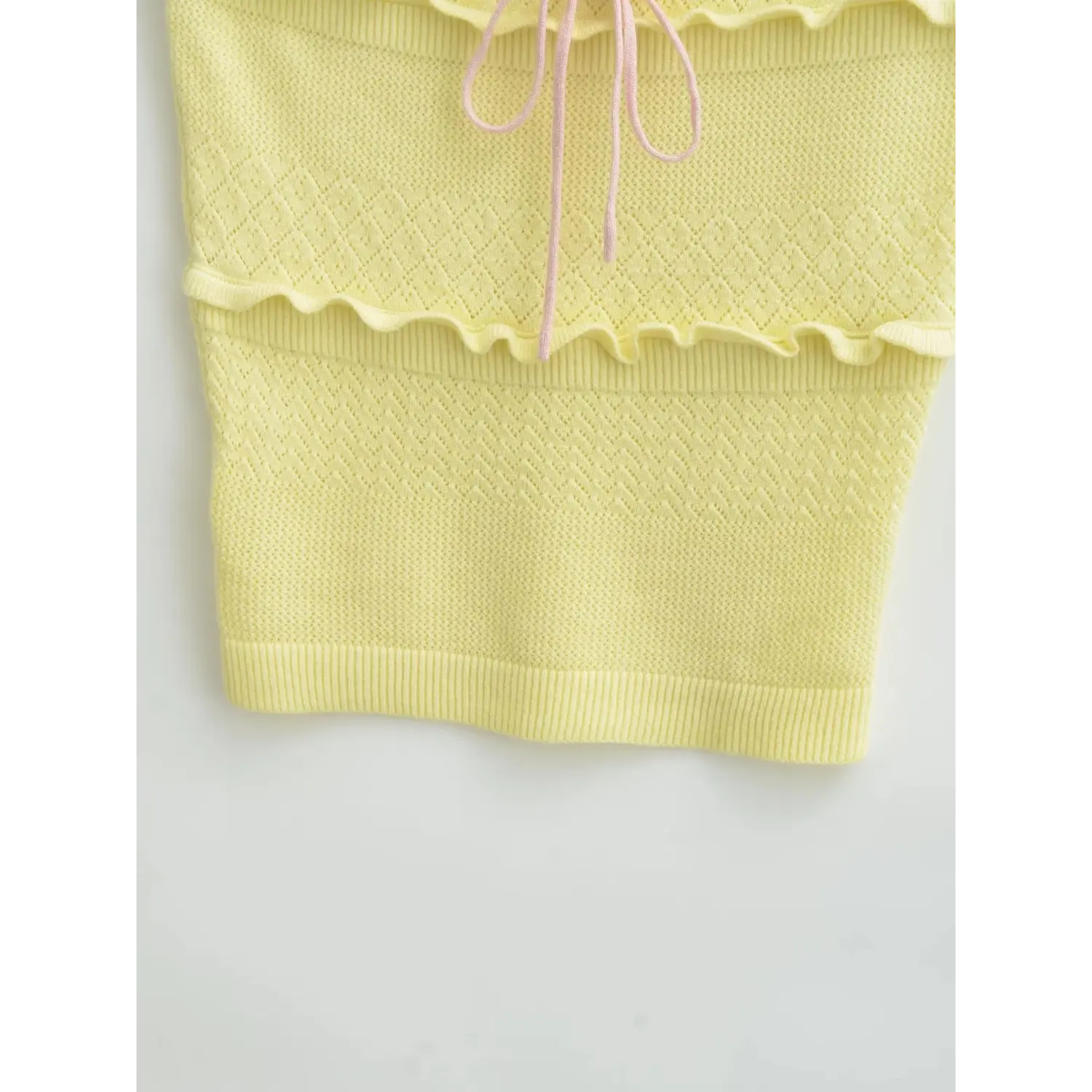 Extreme closeup diamond hollow knit texture & ruffle tier seam on bodice