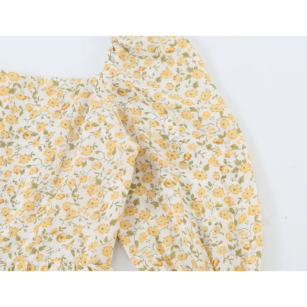 Close-up of square neck and gathered puff sleeve
