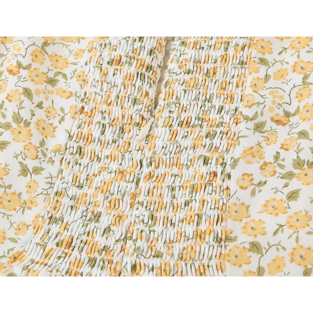 Close-up of smocked back zipper detail