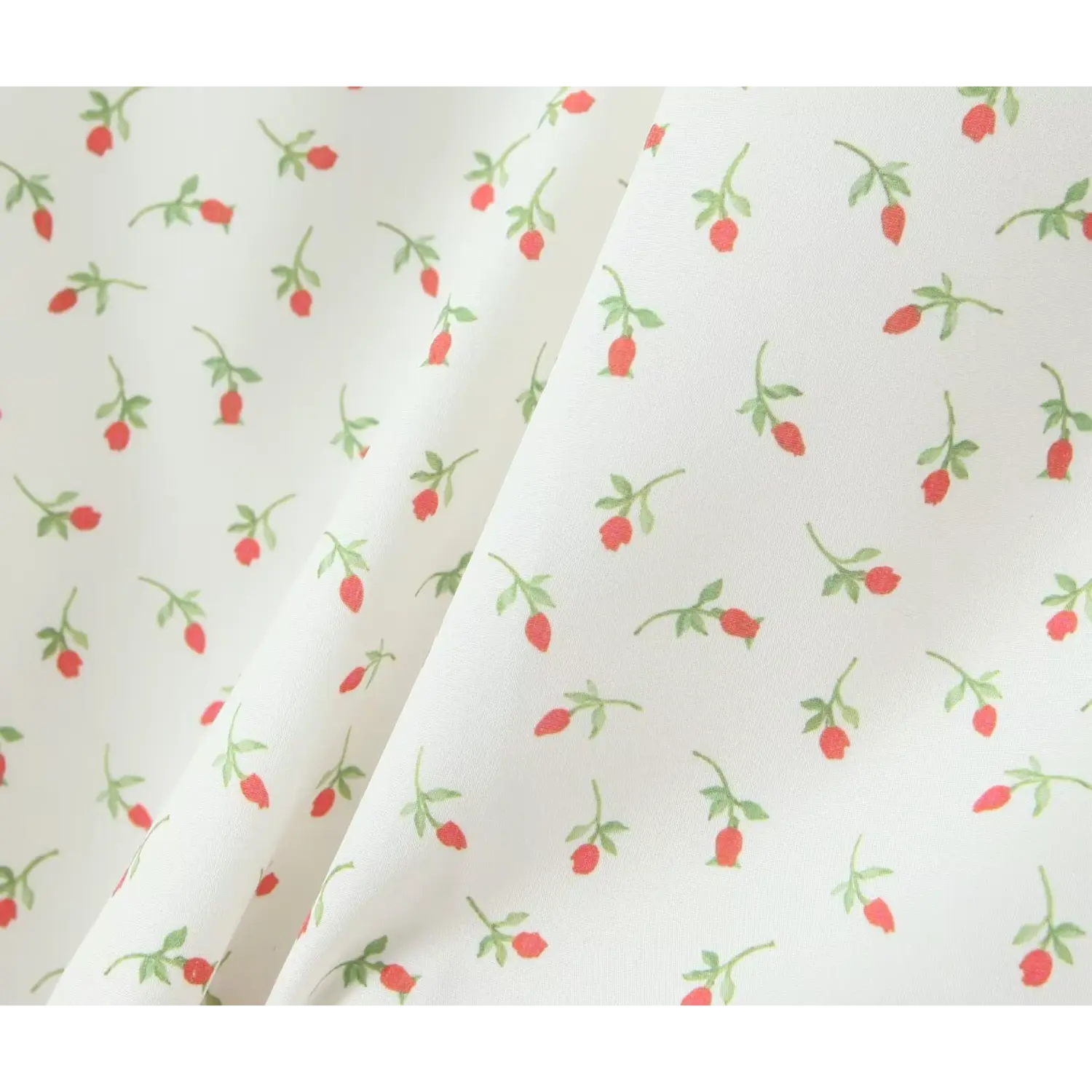 Flat fabric texture close‑up ditsy red rose bud floral pattern on white woven textile drape detail