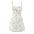 Isolated white background studio front view ditsy rose bud print cami mini dress square ruffle neck front tie