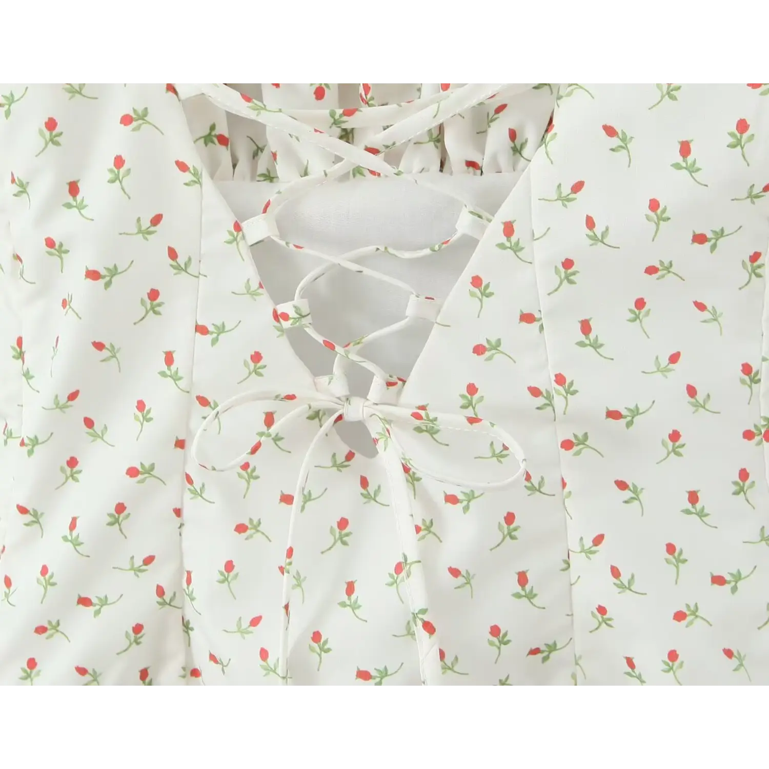 Macro close‑up crisscross lace‑up tie knot detail open back white mini dress tiny red rose bud floral print