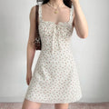 Indoor model wearing shot white ditsy floral cami mini dress fitted bodice a‑line skirt casual styling