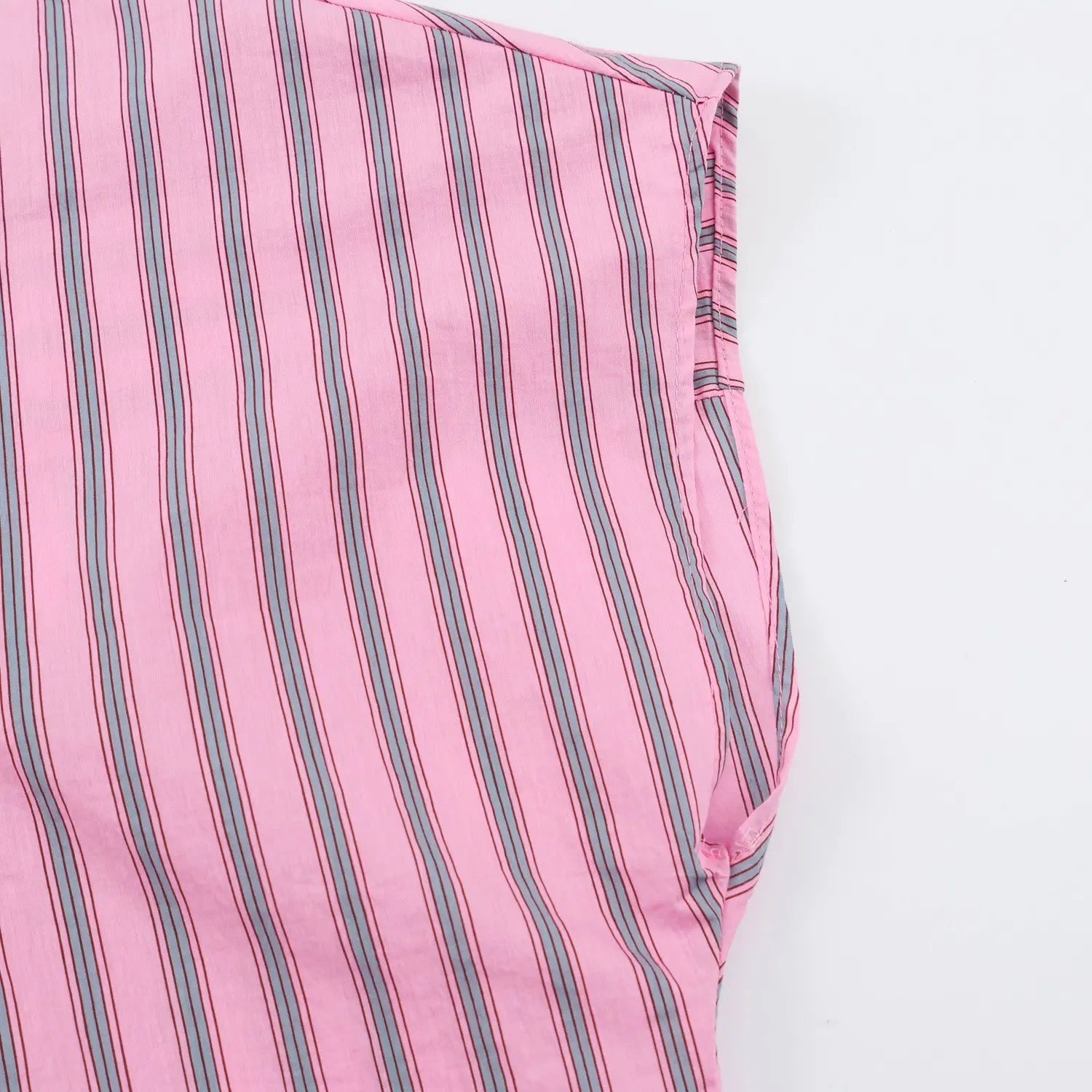 Side view finished loose dolman short sleeve hem, clean overlocked stitching