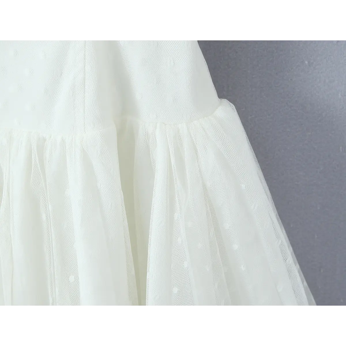 Waist & skirt close, gathered seam transitioning into multi-tier swiss dot sheer tulle mini skirt with solid inner lining.