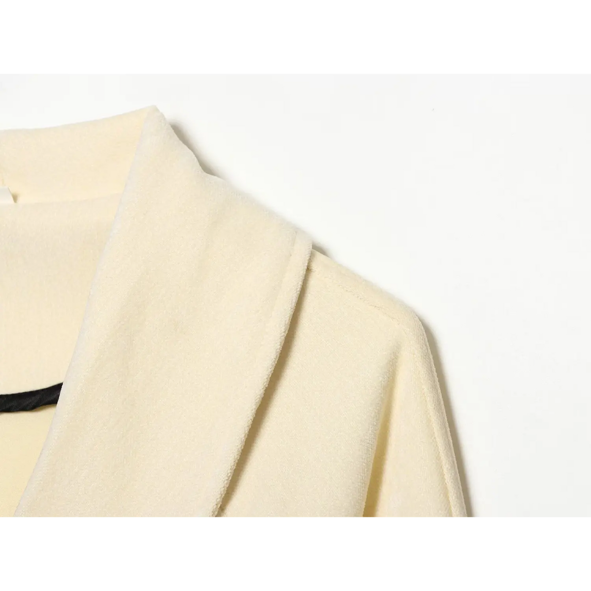 Close-up of cream collar and shoulder seam