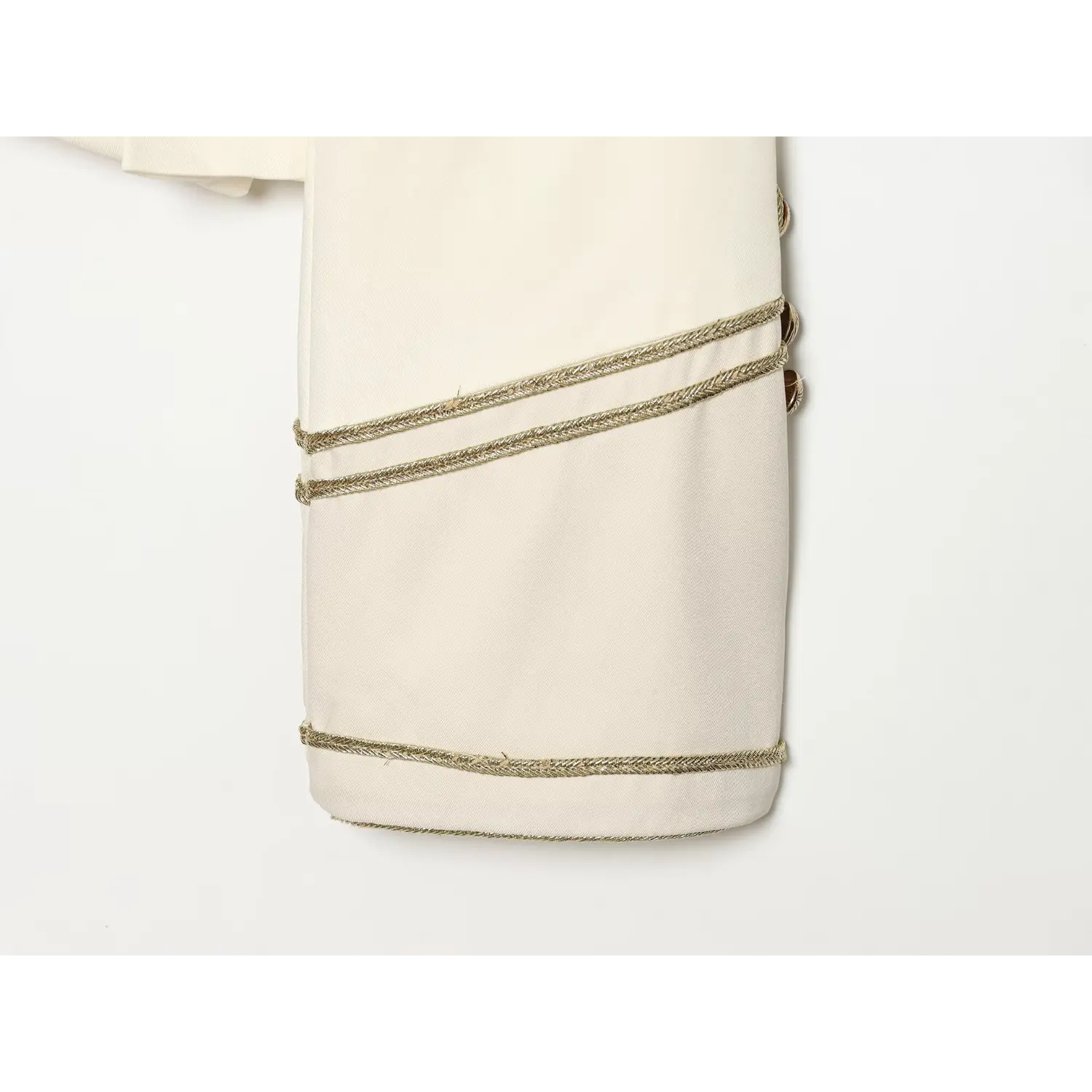 Closeup sleeve cuff, double gold braid trim on off-white cropped blazer
