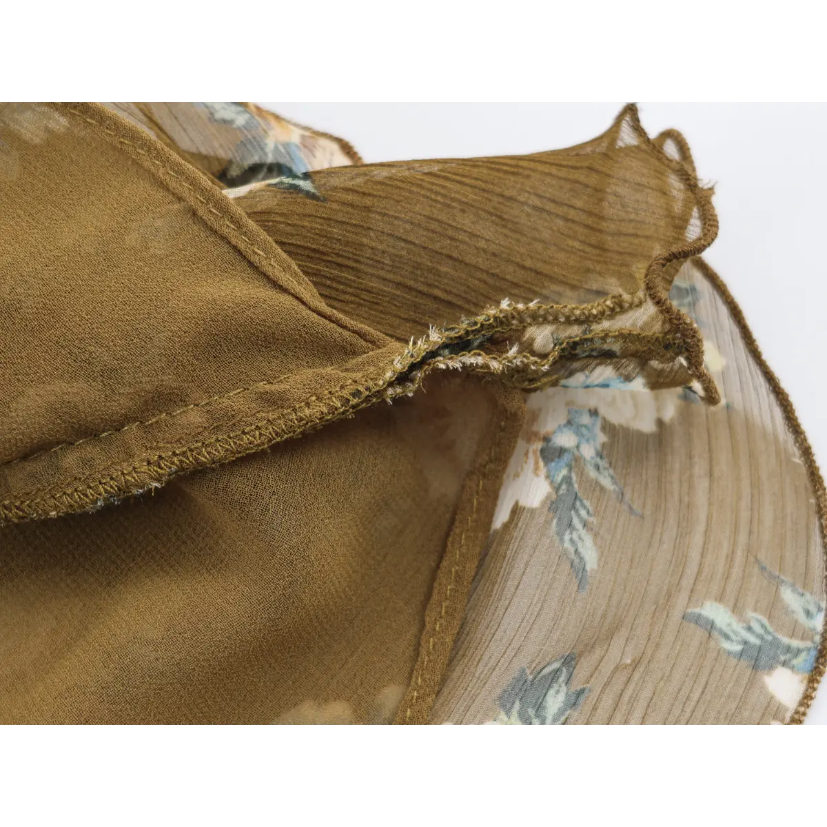  Inner lining close shot, solid khaki smooth lining and overlaid crinkle floral outer chiffon with finished serged seams.