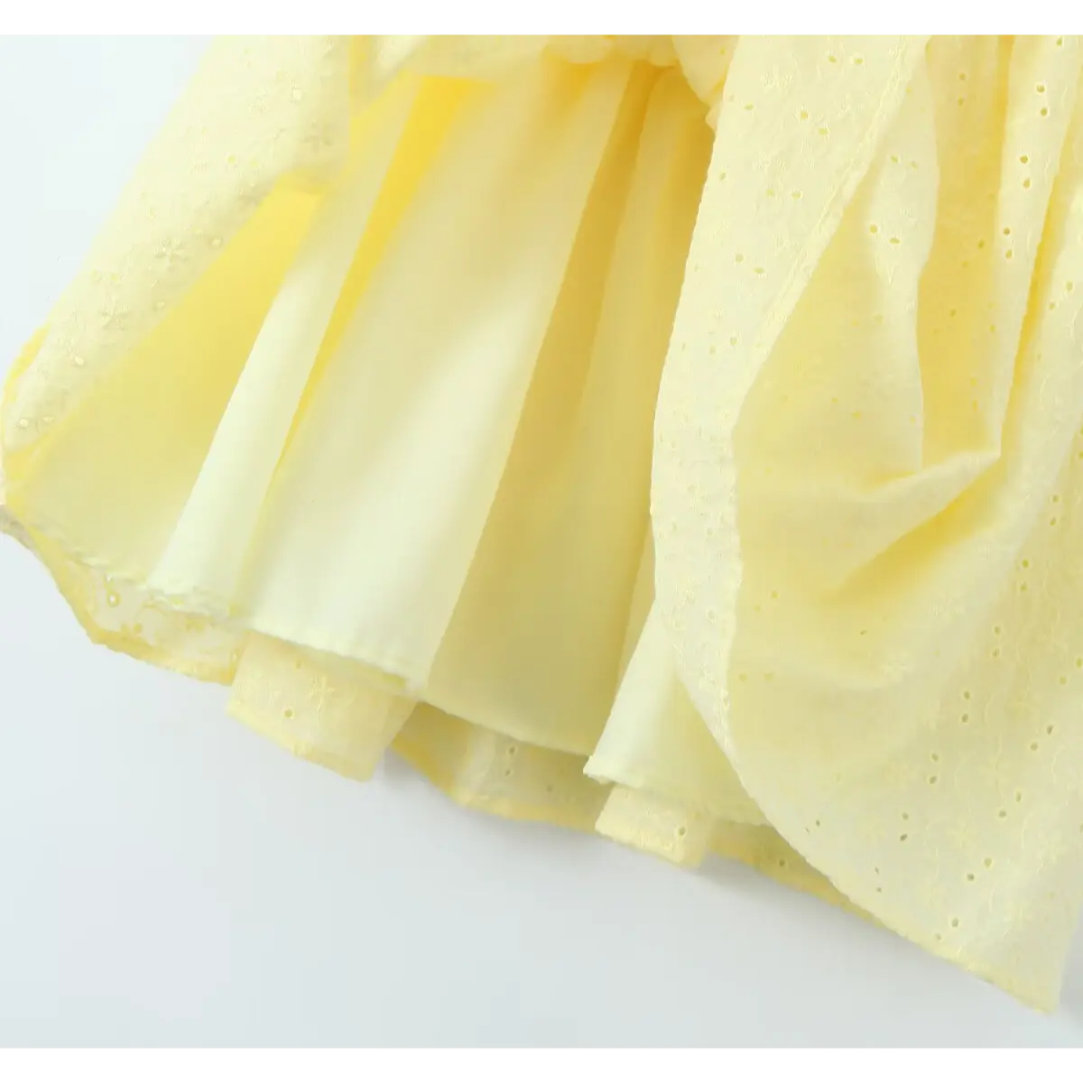 Hem inner view, full solid yellow lining under outer eyelet embroidered skirt, prevent see-through.