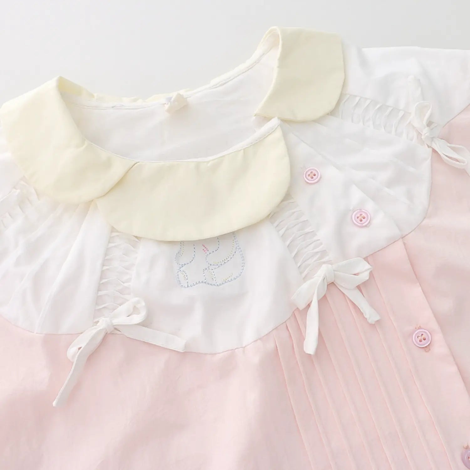 Double layer contrast ruffle doll collar macro close-up, double cream layered frill shoulder detachable white tiny bows bunny embroidery badge shoulder elastic shirring neat fine serging stitch craft shot