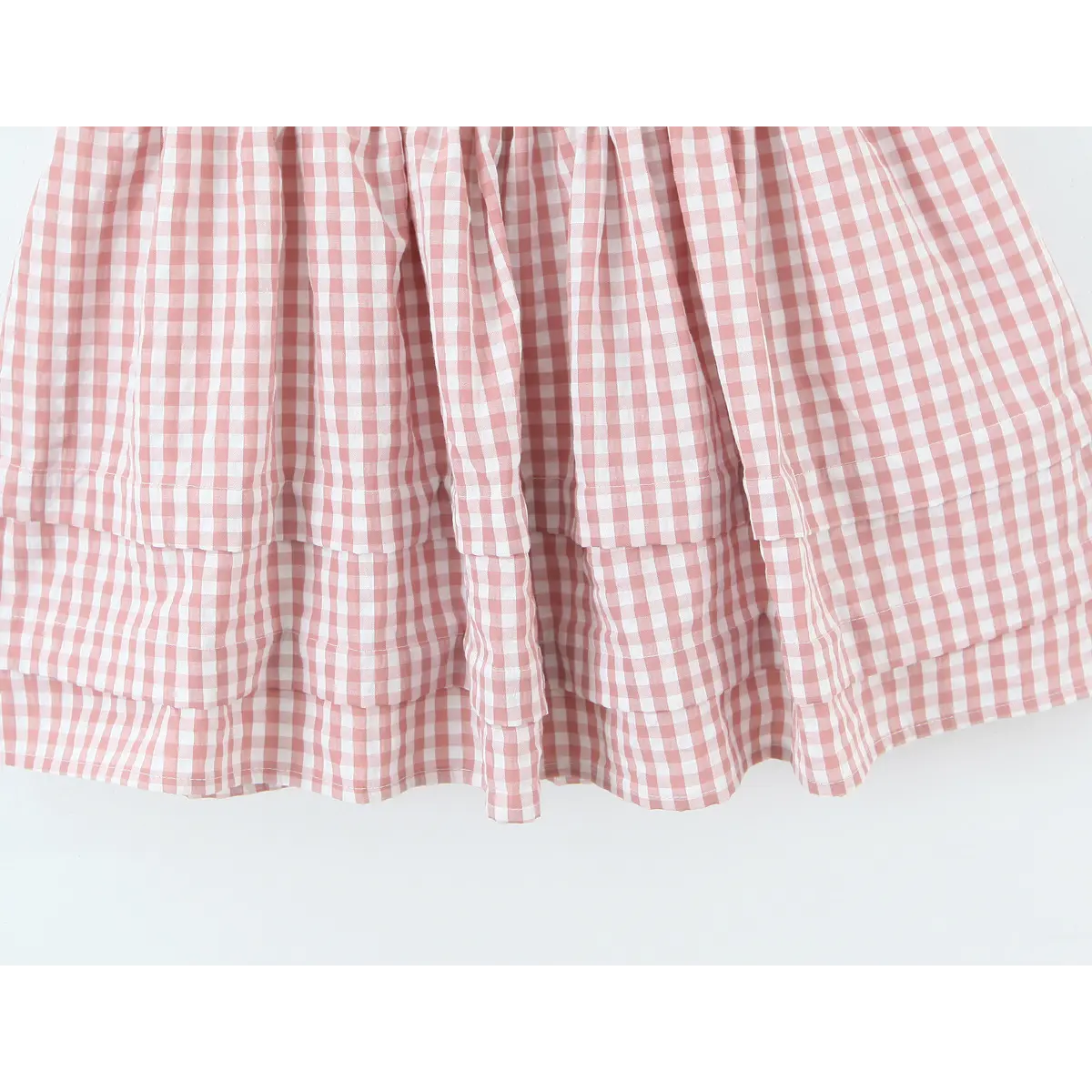 Two tier ruffle hem finished edge detail of gingham skirt