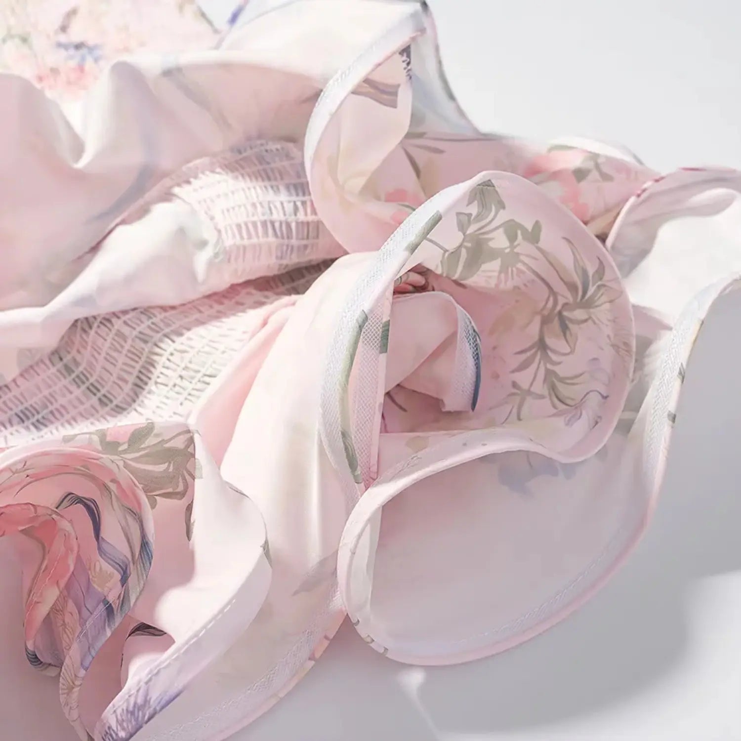 Skirt hem partial shot, two-tier flowy ruffle overlay, lightweight smooth woven lining, matching floral outer shell