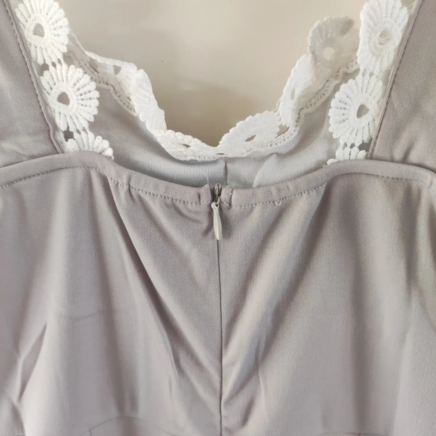 Close‑up back invisible zipper and lace neckline detail of grey sleeveless midi dress