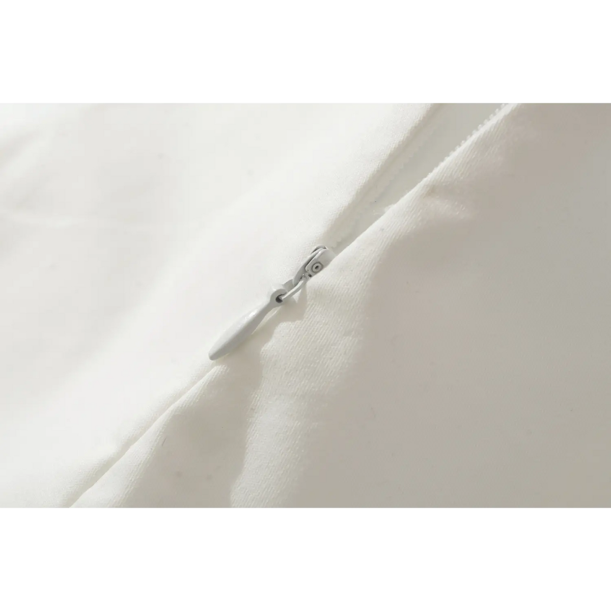 Closeup of white invisible zipper on sleeveless mini dress