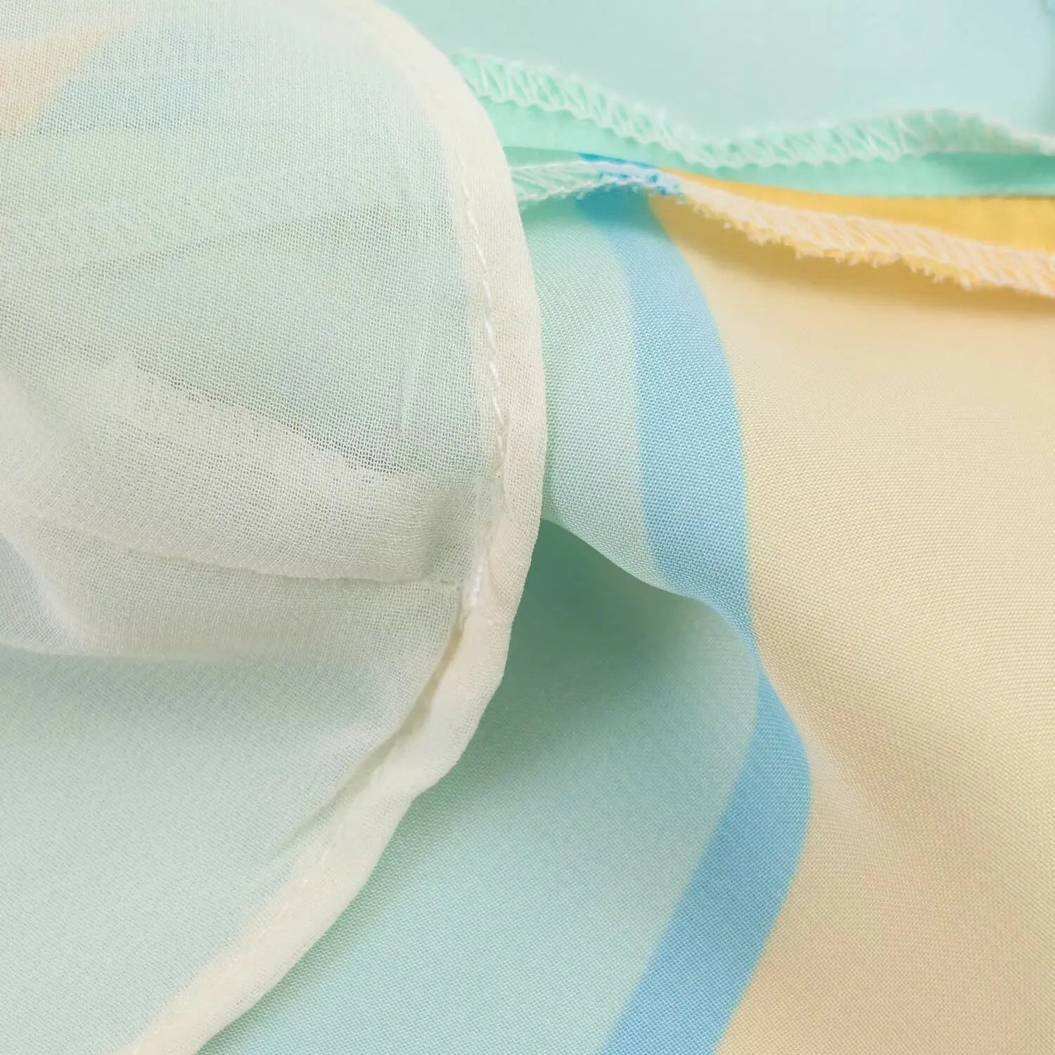 Macro shot of inner lining fabric, lightweight soft lining of abstract print halter mini dress