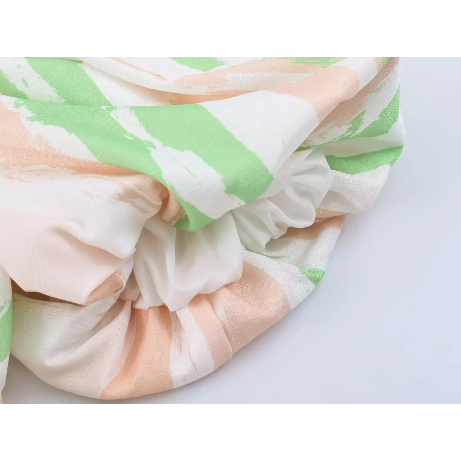 Close shot of soft smooth white inner lining folds, lightweight anti-sheer lining under striped outer woven fabric