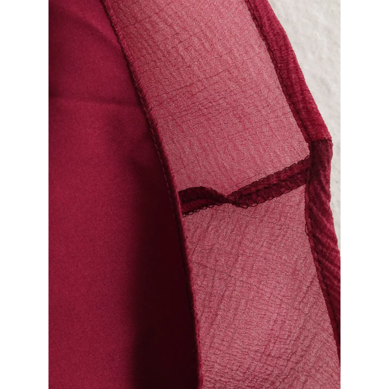  Interior fabric flip shot smooth solid burgundy lining, serged interlock seams connecting lightweight wrinkled outer shell