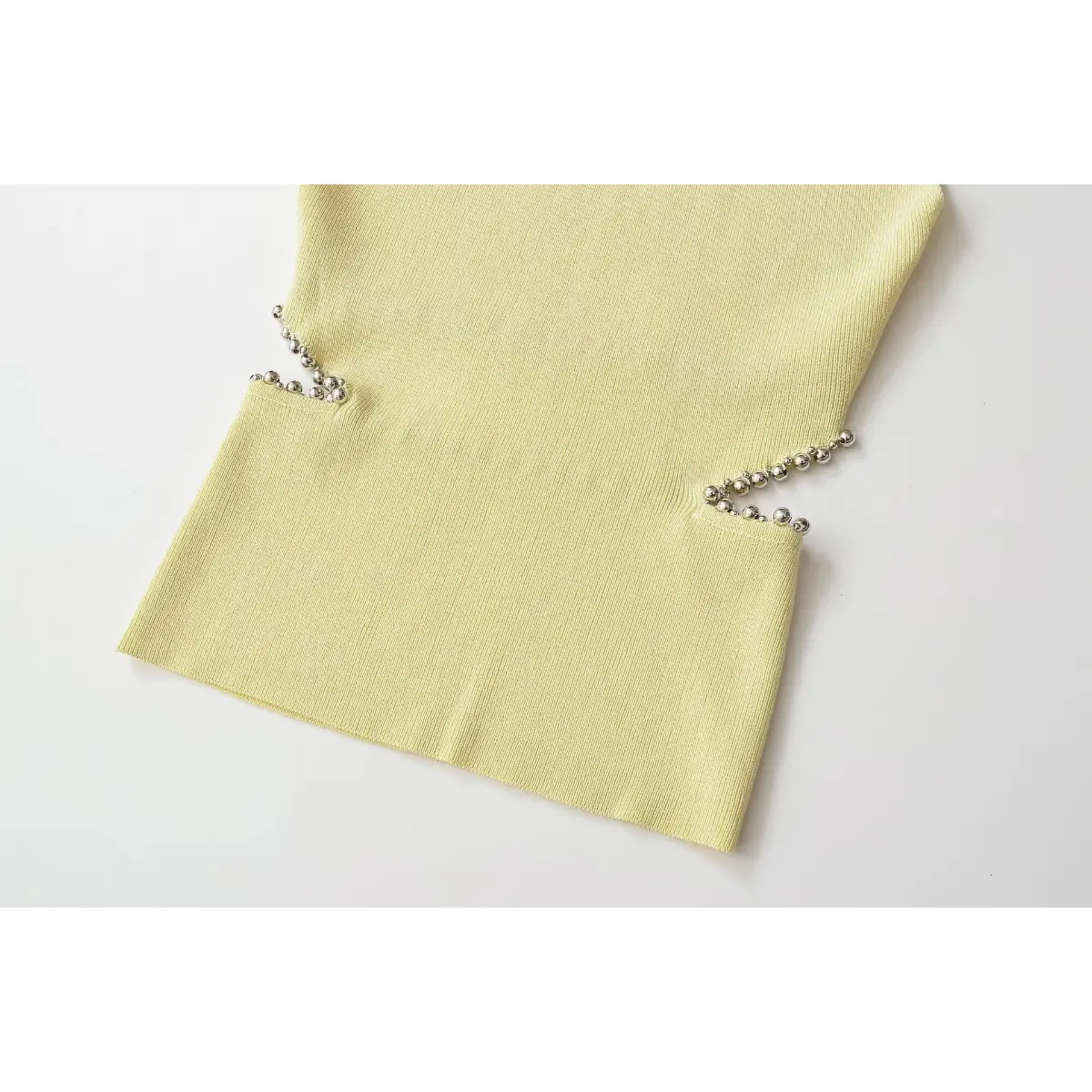 Two side hollow cut with metal bead trim knit vest close shot