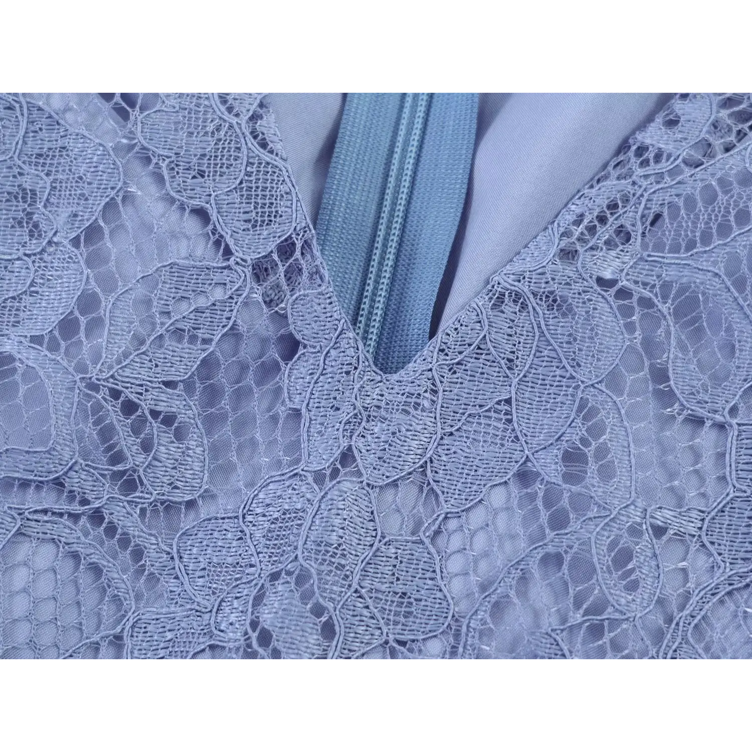 Close‑up v‑neck edge and zipper surrounding floral lace pattern dusty blue dress
