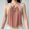 Front lifestyle shot on model of dusty pink halter cami top, front keyhole cutout, cream lace trim, irregular wavy hem