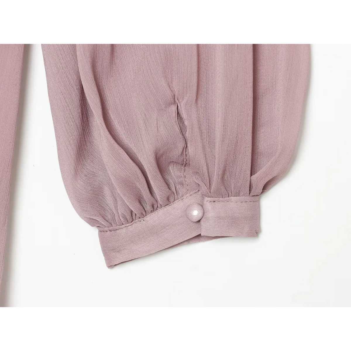 Close-up of pearl button on sleeve cuff