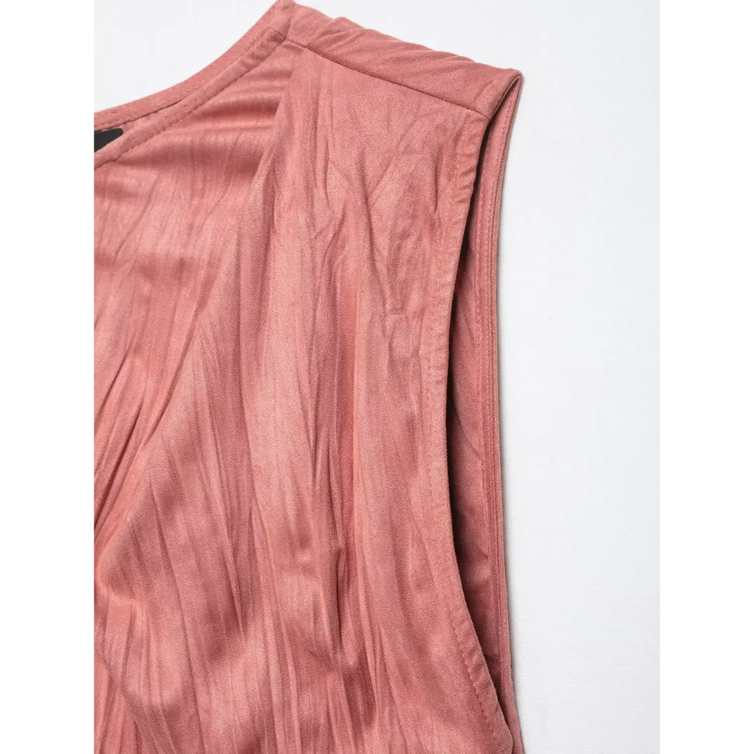 Close-up inner stitching detail of armhole on dusty rose crinkled satin twist shoulder top