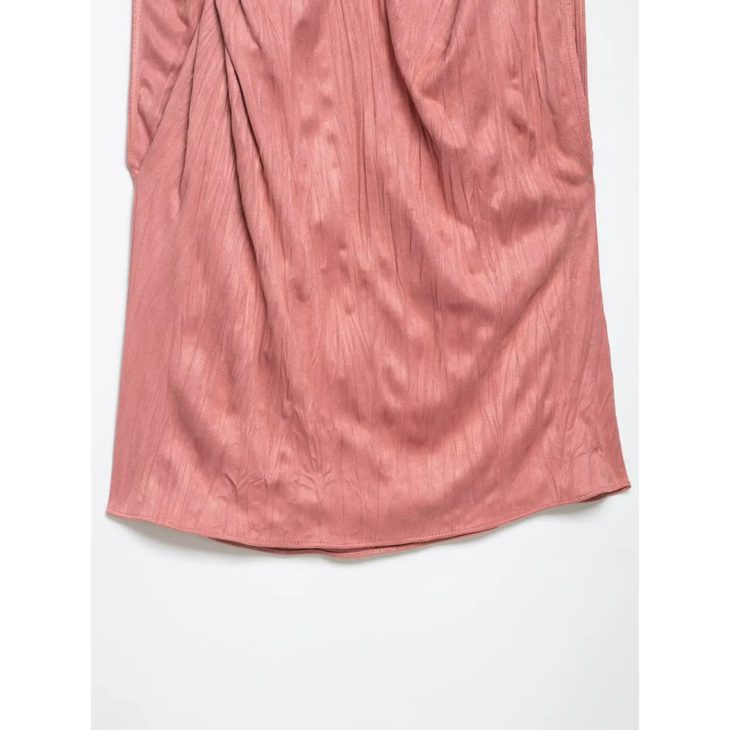 Close-up detail of crinkled satin fabric and hem on dusty rose sleeveless top