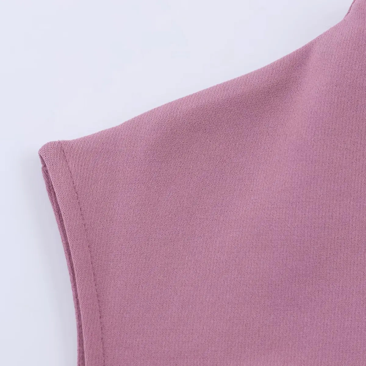 Close-up of the dress's cap sleeve, showing the clean, tailored seam and the fine texture of the knit fabric.
