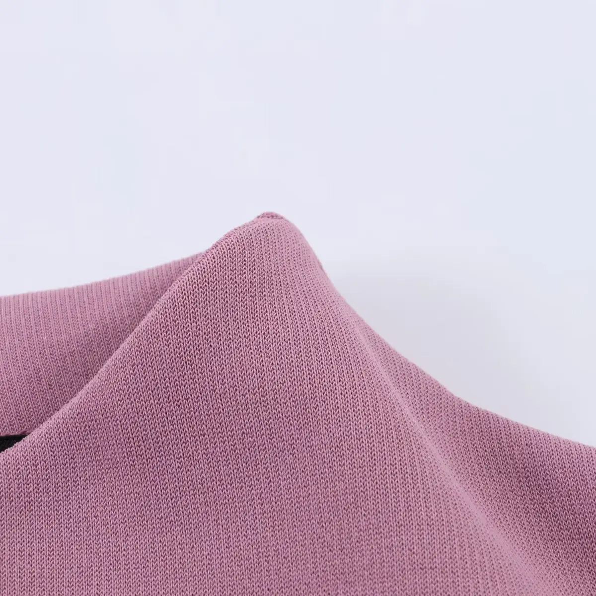 Close-up of the dress's main knit fabric, showcasing its smooth texture, fine weave, and soft drape.