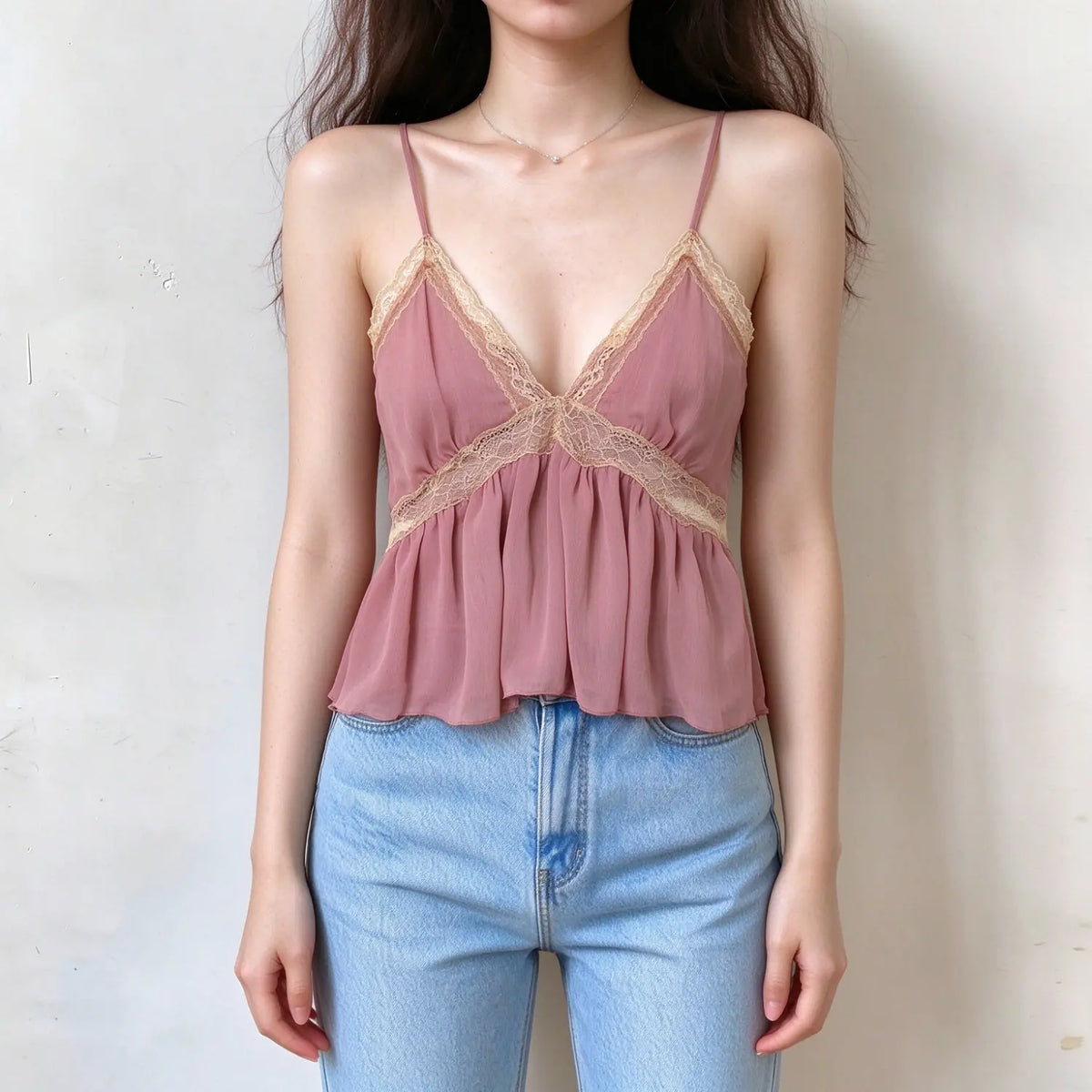 Model wearing dusty rose lace trim chiffon cami top with jeans, front view