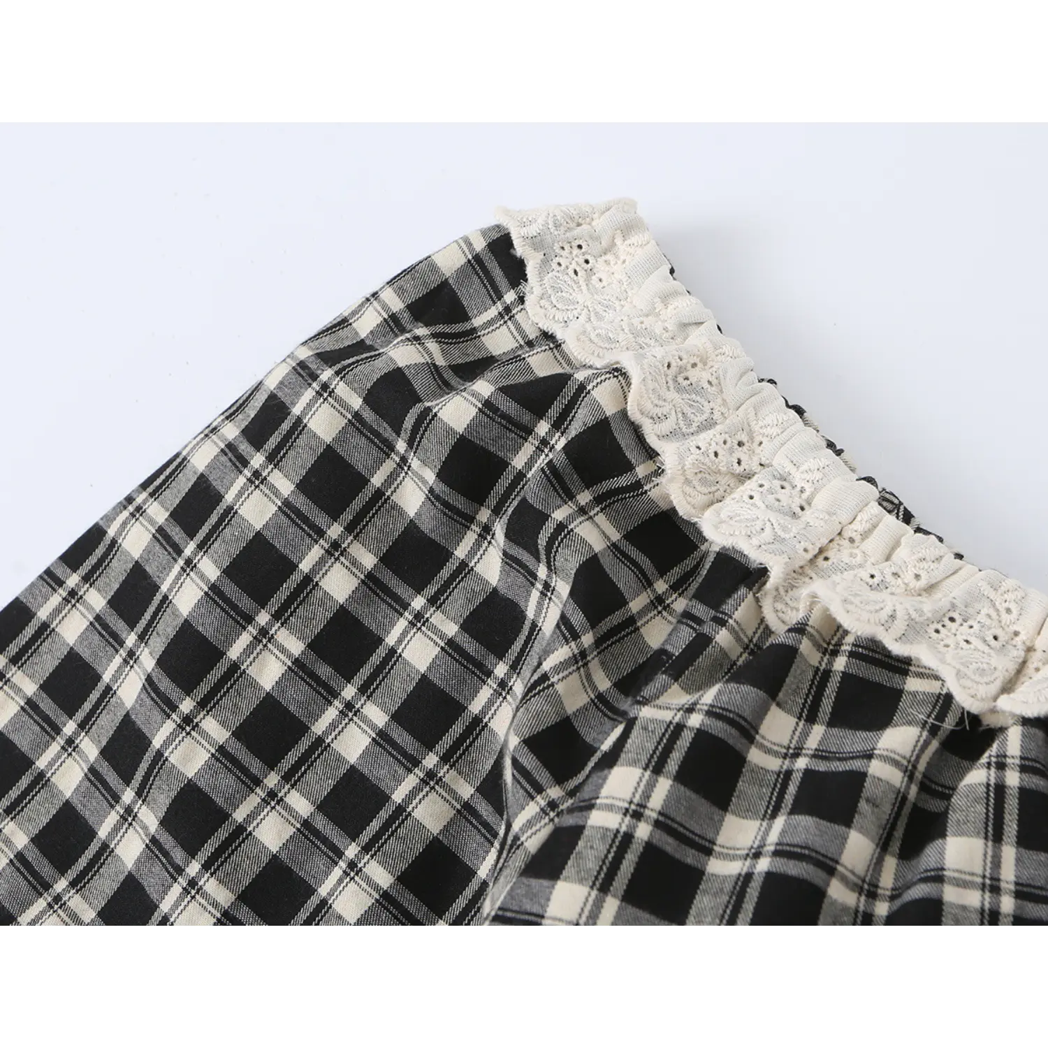 Neckline partial close-up stretch elastic off-white eyelet lace trim, gathered ruffle square neck spliced with black cream plaid woven fabric