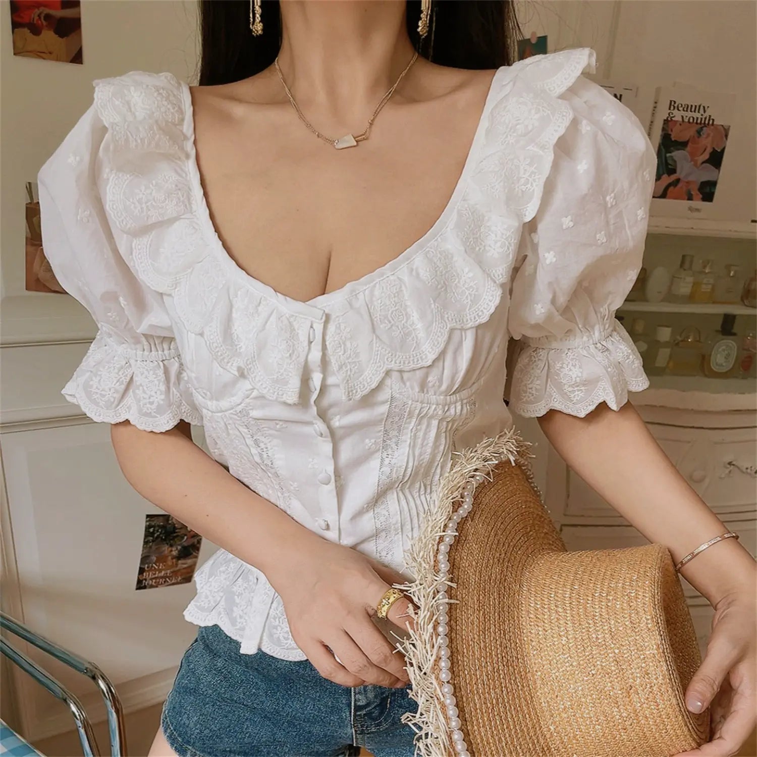 Cottagecore outfit photo white lace ruched corset blouse, holding pearl trim straw hat, scallop ruffle square neck fitted summer top