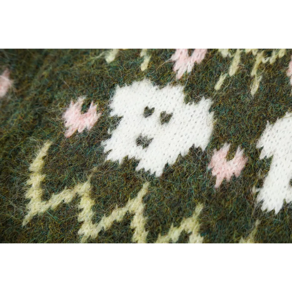 Close-up of white animal face intarsia knit detail