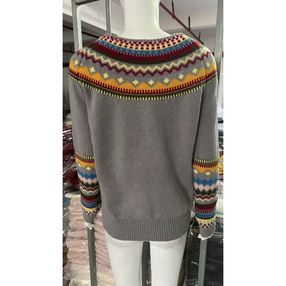 Back view of fair isle yoke striped knit sweater on mannequin