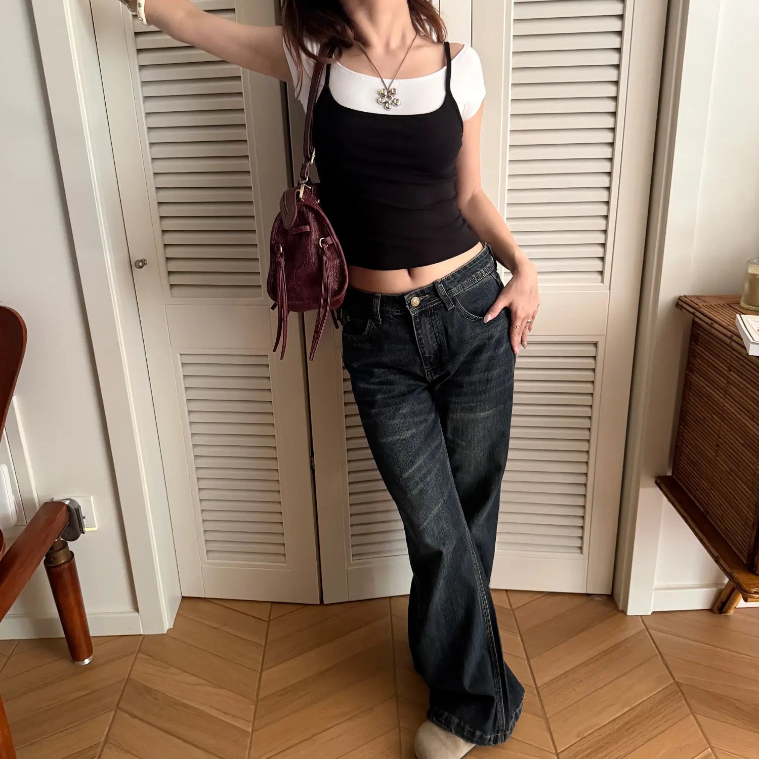 Fake two piece black white layered camisole full body model shot, double layer u short sleeve + square strap combo curved cropped hem matched with dark wide leg jeans complete daily outfit display