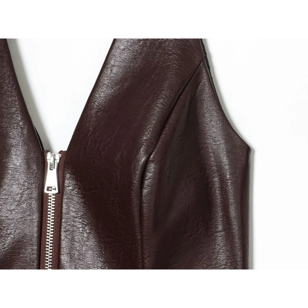 Close-up of brown armhole and zipper detail