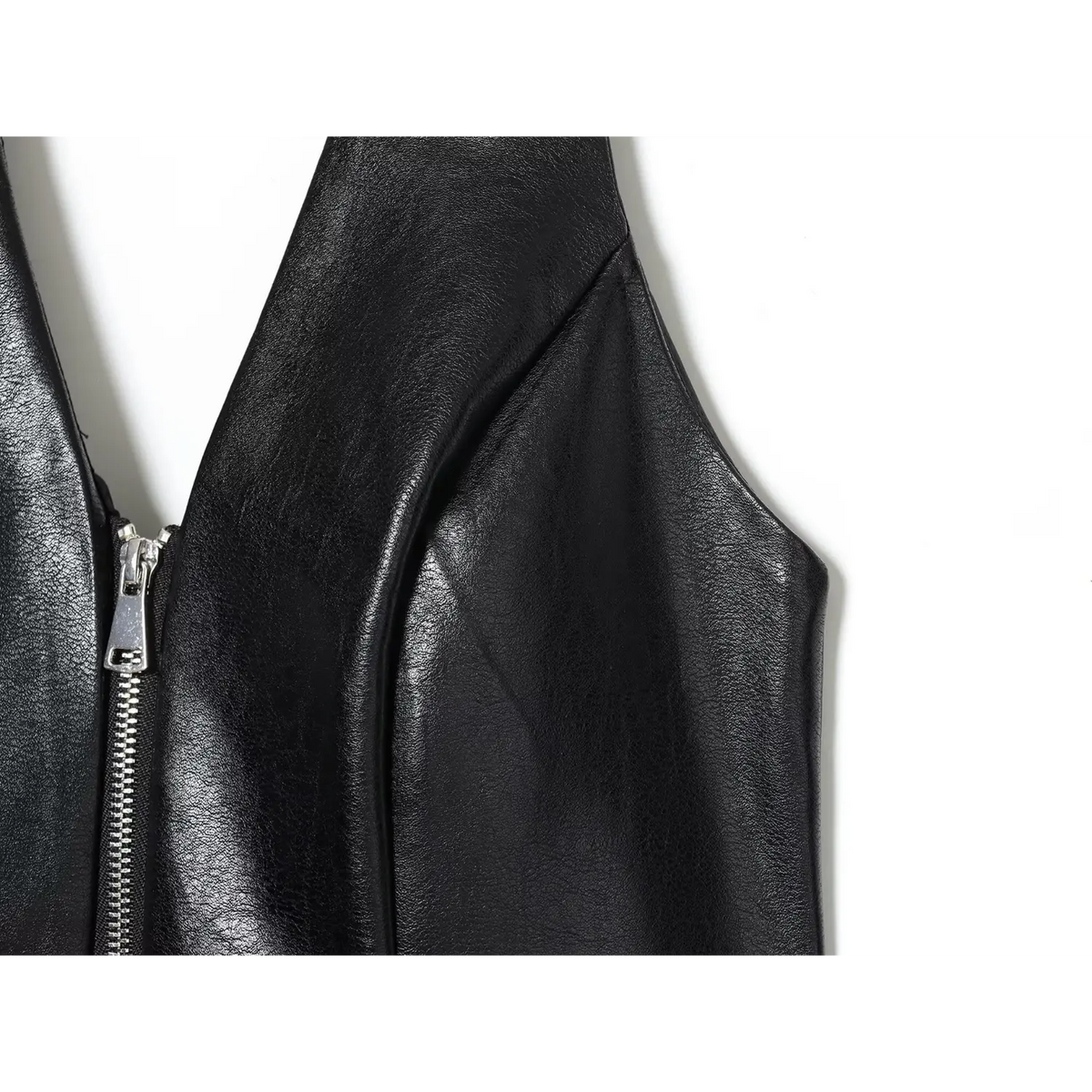 Close-up of black armhole and zipper detail